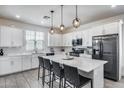 Bright kitchen with a large island, modern appliances, and stylish pendant lighting at 651 N Bay Dr, Gilbert, AZ 85233
