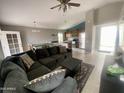 Inviting living room featuring tile floors, a large couch, and natural light at 7026 S 40Th Pl, Phoenix, AZ 85042