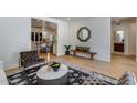 Open-concept living area with hardwood floors, modern decor, stylish furniture, and a view into the kitchen at 7348 N 9Th Pl, Phoenix, AZ 85020