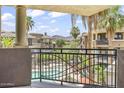 Balcony view of community pool and lush landscaping, with palm trees and mountains at 7601 E Indian Bend Rd # 3030, Scottsdale, AZ 85250