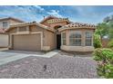 Delightful single-Gathering home showcases a two-car garage, xeriscaping, and a charming window, all contributing to a warm, welcoming feel at 7949 W Wescott Dr, Glendale, AZ 85308