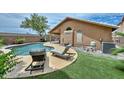 Backyard with a private pool, artificial turf, and lounge chairs near the house at 7949 W Wescott Dr, Glendale, AZ 85308