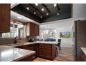 Modern kitchen featuring stainless steel appliances, granite countertops, and wood cabinets at 8732 E Sandalwood Dr, Scottsdale, AZ 85250