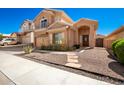 Beautiful home with desert landscaping, stone walkway, and inviting front entrance at 10723 N 118Th Way, Scottsdale, AZ 85259