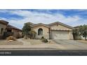 Beautiful single-story home with desert landscaping and a convenient two-car garage at 14380 W Monte Vista Rd, Goodyear, AZ 85395
