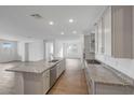 Open-concept kitchen with large island, stainless appliances, and spacious pantry at 14789 W Lariat Ln, Surprise, AZ 85387