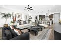 Open-concept living room features stylish furnishings and seamless flow into the kitchen at 14789 W Lariat Ln, Surprise, AZ 85387