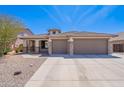 Charming home with stone accents, 3-car garage, and desert landscaping creates curb appeal at 1520 N Milly Pl, Casa Grande, AZ 85122