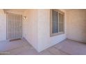 Close-up of the front porch with a secure door, an accent window and desert-style accents at 1520 N Milly Pl, Casa Grande, AZ 85122
