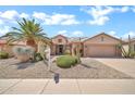 Lovely single-Gathering home featuring desert landscaping, a two-car garage, and a lush, green lawn at 15534 W Big Sky Dr, Surprise, AZ 85374