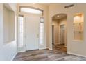 Bright foyer with wood-look tile, arched doorways, and abundant natural light at 1555 E Monterey St, Chandler, AZ 85225