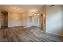 Open-concept living room with wood-look tile, recessed lighting, and adjacent dining area at 1555 E Monterey St, Chandler, AZ 85225
