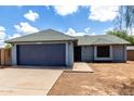 Charming single-story home featuring a well-maintained lawn, wide driveway, and attached two-car garage at 161 S Maple St, Chandler, AZ 85226
