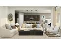 Open concept living room features neutral tones, modern furnishings and flows into the kitchen and dining room at 17403 W Swayback Pass, Surprise, AZ 85387