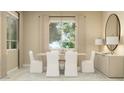 Bright dining room featuring neutral tones, a modern chandelier, and elegant decor at 17411 W Swayback Pass, Surprise, AZ 85387