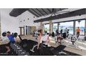 Modern gym with various fitness equipment and large windows overlooking the pool area at 17411 W Swayback Pass, Surprise, AZ 85387