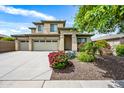 Charming two-story home with a three car garage, landscaped yard, and vibrant desert vegetation at 19242 W Pasadena Ave, Litchfield Park, AZ 85340