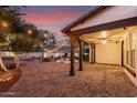 Covered patio with pillars overlooks the pool and fire pit, ideal for entertaining at 20412 W Thayer St, Buckeye, AZ 85396