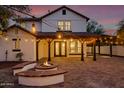 Covered patio with fire pit and built-in seating is perfect for outdoor gatherings at 20412 W Thayer St, Buckeye, AZ 85396