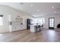 Bright kitchen with white cabinets, a large island, and stainless steel appliances at 2309 W Naranja Ave, Mesa, AZ 85202