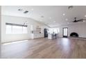 Spacious living room featuring an open floor plan and modern lighting fixtures at 2309 W Naranja Ave, Mesa, AZ 85202