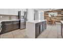 Modern kitchen featuring stainless steel appliances, white cabinetry, and an island with bar seating at 2405 W Memorial Dr, Anthem, AZ 85086