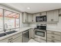 Well-lit kitchen featuring stainless steel appliances, sleek countertops, and ample cabinet space at 2605 E Fountain St, Mesa, AZ 85213