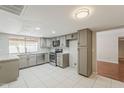 Bright, open kitchen with stainless steel appliances and tile flooring at 2605 E Fountain St, Mesa, AZ 85213