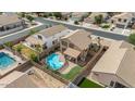 An aerial view of a private backyard featuring a sparkling pool and covered patio at 4323 E Dublin St, Gilbert, AZ 85295