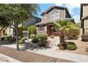 Charming two-story home with desert landscaping and a young palm tree in the front yard at 4380 E Renee Dr, Phoenix, AZ 85050