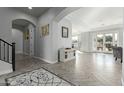 Grand foyer with exquisite flooring, arched doorways, and a view into the spacious interior at 4497 E Carriage Way, Gilbert, AZ 85297