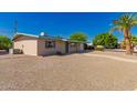 Exterior view of home featuring low maintenance yard, quaint porch, and one-car garage at 5627 E Covina Rd, Mesa, AZ 85205