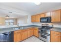 Well-lit kitchen with wooden cabinets and stainless steel appliances at 645 W Kingman Loop, Casa Grande, AZ 85122
