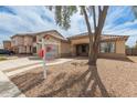 A single-story home featuring desert landscaping, a two-car garage, and a walkway leading to the entrance at 681 W Racine Loop, Casa Grande, AZ 85122