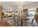 Open dining area with chandelier, Saltillo floors and seamless access to the living area at 7526 E Edgemont Ave, Scottsdale, AZ 85251