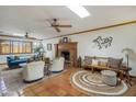 Relaxing living area with Saltillo tile floors, and a traditional brick fireplace at 7526 E Edgemont Ave, Scottsdale, AZ 85251
