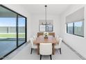 Modern dining room features a large table, neutral decor, and sliding glass doors at 812 E Summerside Rd, Phoenix, AZ 85042