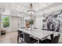 Dining room featuring stylish lighting, artwork, and laminate wood floors at 8787 E Mountain View Rd # 2100, Scottsdale, AZ 85258