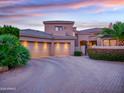 Attractive home exterior featuring a three-car garage, beautiful landscaping and elegant curb appeal at 9878 N 79Th Pl, Scottsdale, AZ 85258
