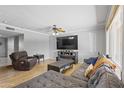 Spacious living room with a large sectional sofa, hardwood floors, and ample natural light at 12639 N 47Th Ave, Glendale, AZ 85304