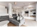 Cozy living room featuring a gray sectional sofa, accent pillows, and adjacent open shelving at 12642 N Mountainside Dr # B, Fountain Hills, AZ 85268