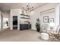 Bright living space featuring a dry bar, modern chandelier, and view into another room at 12642 N Mountainside Dr # B, Fountain Hills, AZ 85268