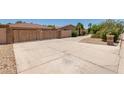 Long driveway leading to a spacious home, framed by desert landscaping and mature greenery at 12837 N 68Th St, Scottsdale, AZ 85254