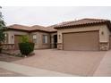 Attractive home with a three car garage and desert landscaping at 14376 W Desert Hills Dr, Surprise, AZ 85379