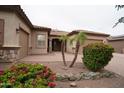 Charming front yard features desert landscaping, a paver walkway, and a two car garage at 14376 W Desert Hills Dr, Surprise, AZ 85379