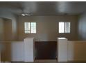 Bright hallway with dark wood floors and white paint at 14376 W Desert Hills Dr, Surprise, AZ 85379