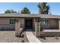 Inviting home exterior showcasing a tidy yard and a welcoming entrance with a double door at 2156 E Cairo Dr, Tempe, AZ 85282