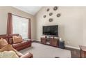 Cozy living room with a plush leather couch, a large TV, and neutral decor for a relaxing atmosphere at 2508 N Karen Dr, Chandler, AZ 85224