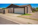 Attached two-car garage featuring a white door and modern architectural details at 2826 E Cactus Rd, Phoenix, AZ 85032