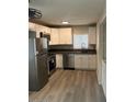 Bright kitchen featuring stainless steel appliances and ample cabinet space at 286 W Palomino Dr # 105, Chandler, AZ 85225